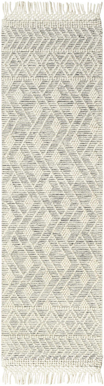 Close-up of the Erica Wool Rug with Tassels. Features a bone and cloud gray geometric pattern and hand-woven texture. Design-Runner-2376