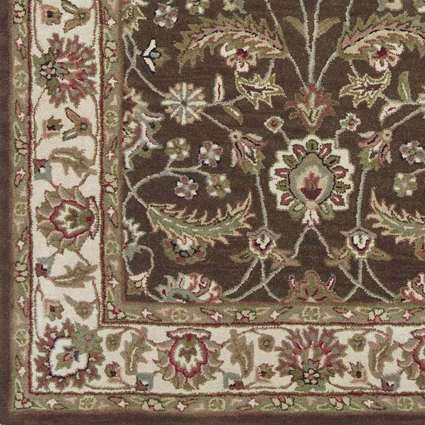 Close-up of the Eupora Wool Rug. Brown rug with a traditional floral pattern in red, olive, and cream. Hand-tufted texture. Swatch