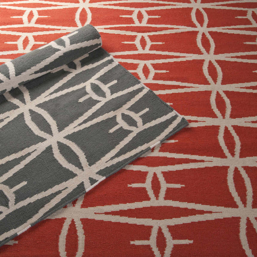 Close-up of the Lipan Area Rug in charcoal and peach, showcasing its hand-woven, geometric design. Styleshot
