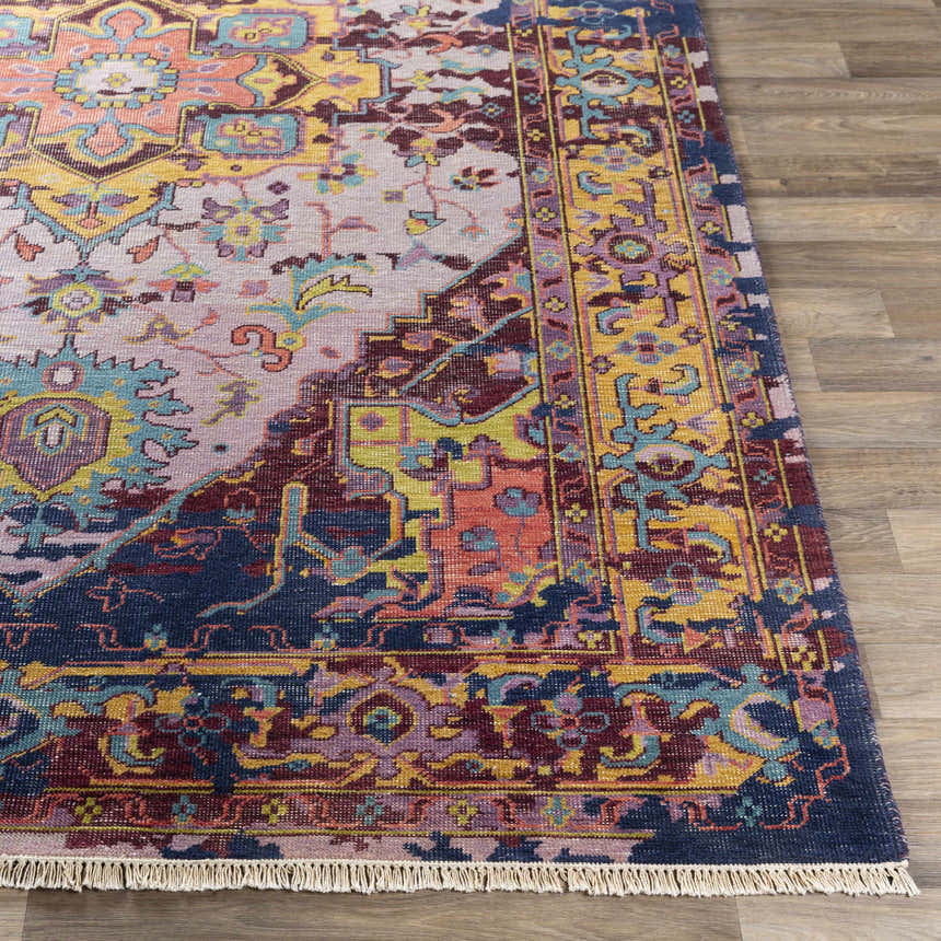 Close-up of the hand-knotted Flagtown Area Rug. Bohemian style with blue, coral, purple, and mustard colors. 100% wool texture. Front