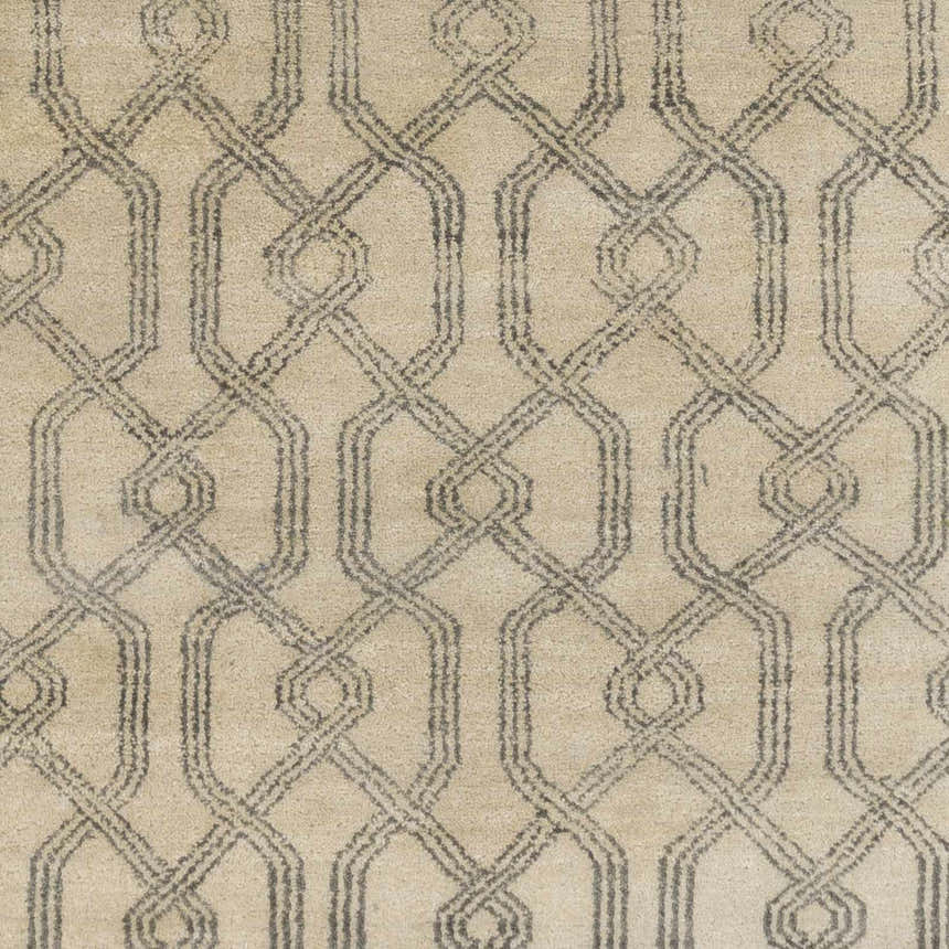 Close-up of the Fairborn Wool Rug. Charcoal and taupe geometric pattern on a hand-knotted wool rug. Swatch