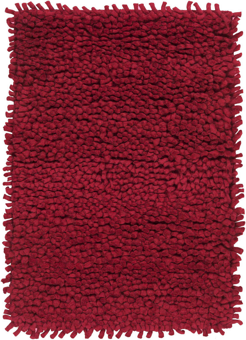 Close-up of a Frederika Solid Dark Red Wool Shag Rug, showing its dense shag texture and hand-woven construction. Design-Rectangle-23