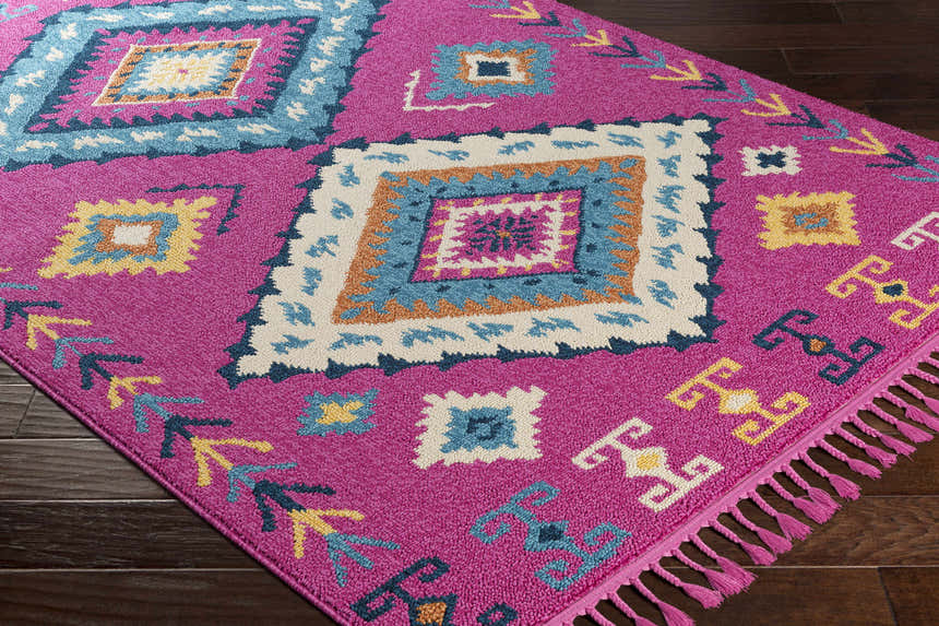 Close-up of Franktown Magenta Carpet featuring a Bohemian diamond pattern in aqua, blue, camel, and fuchsia. Corner