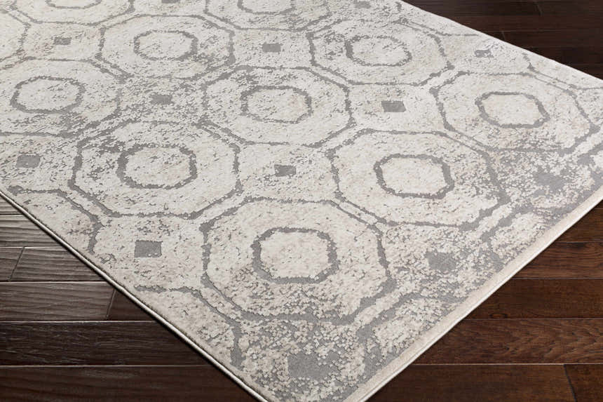 Close-up of the Frenchtown Area Rug, a clearance item with a geometric pattern in neutral beige and gray tones. Corner