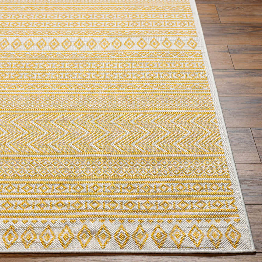 Close-up of the Galal Area Rug showing its beige and dark orange geometric pattern and machine-woven texture. Front