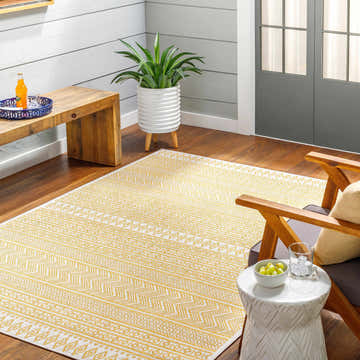 Bright sunroom with a yellow and white geometric Galal Area Rug, wood floors, and casual seating. Roomscene-Rectangle
