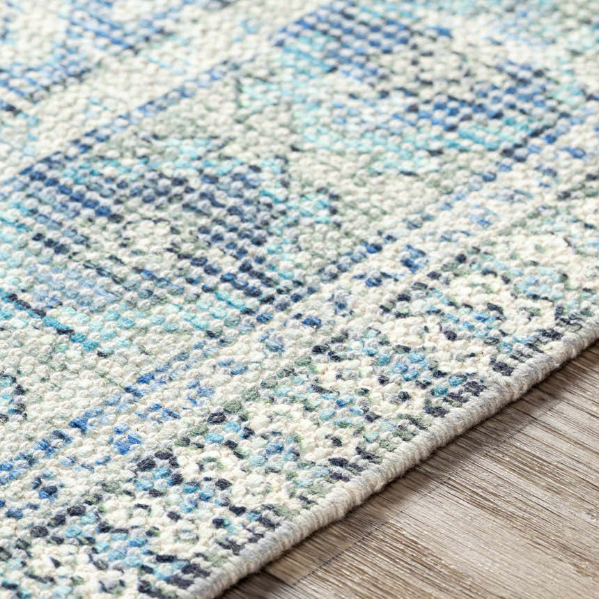 Close up of the hand woven Galgate Area Rug with aqua, teal, and white farmhouse design. Texture