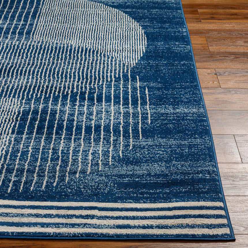 Close-up of the Gent Area Rug. Harbor blue rug with a contemporary geometric pattern of white lines and circles. Front