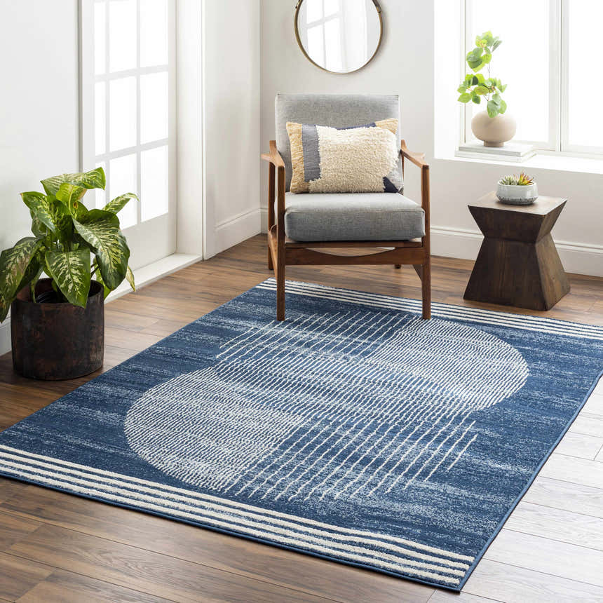 Living room scene with a harbor blue Gent Area Rug featuring a white geometric pattern. Roomscene-Rectangle