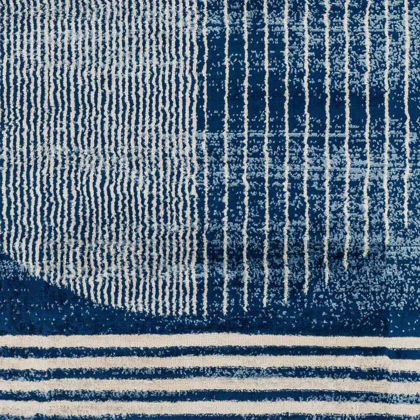 Close-up of the Gent Area Rug showing a geometric pattern in harbor blue and white stripes. Contemporary style. Swatch