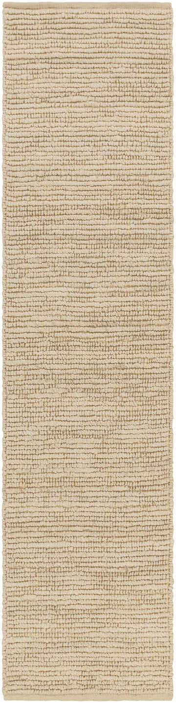Close-up of the Glover Bleached Braided Jute Carpet. The rug has a textured, hand-woven design in bleached jute, ivory, and natural jute. Design-Runner-28