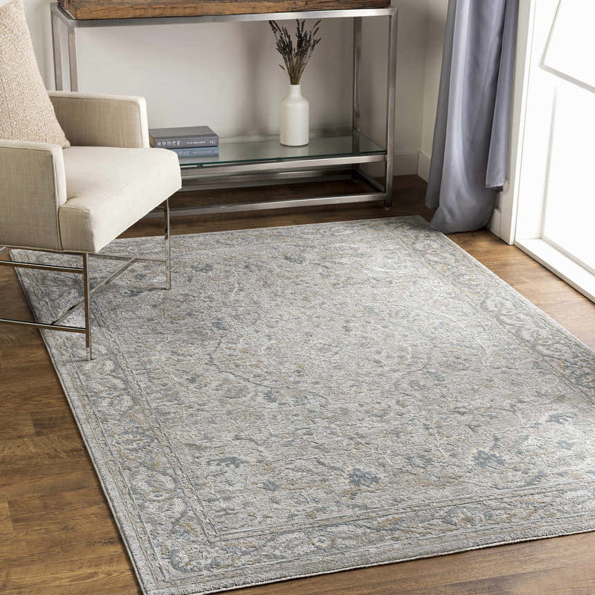 Living room scene with a Glengarry Thick Luxe Boutique Rug in dusty sage, light beige, and gray under a chair. Roomscene-Rectangle
