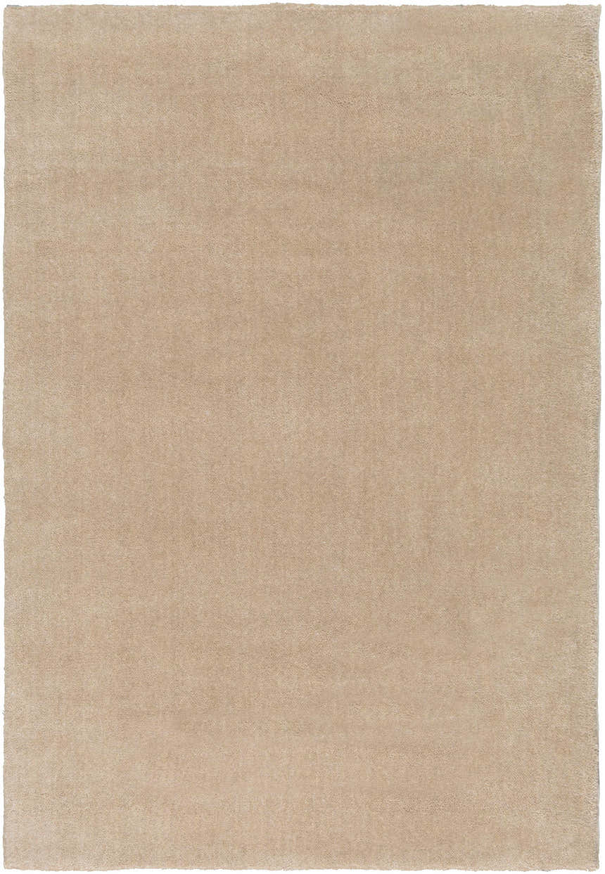 Close-up of a solid, hand-loomed Galata Area Rug in a soft beige. Viscose and wool blend shows subtle texture. Design-Rectangle-23