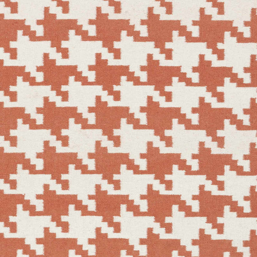 Close-up of the Goldthwaite Area Rug. Burnt orange and light beige houndstooth pattern on a hand woven, 100% wool rug. Swatch