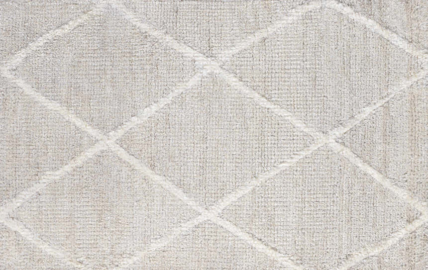 Close-up of the Gonvick Area Rug. Light gray rug with a raised off white diamond pattern. Hand knotted viscose texture. Swatch