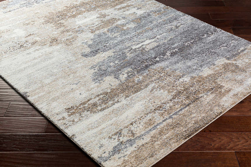Close-up of the Gonen Thick Luxe Rug. Abstract design in dark brown, gray, light gray, and nutmeg colors. Corner