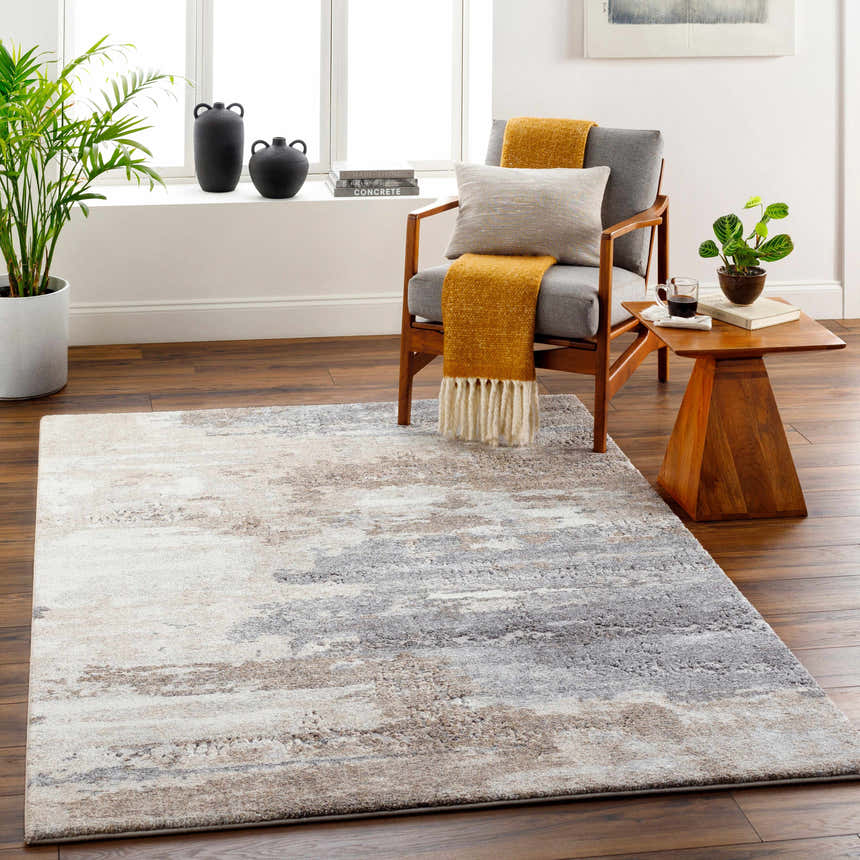 Living room scene with a Gonen Thick Luxe Rug in gray, brown, and white. Contemporary chair, wood floors, and natural light. Roomscene-Rectangle