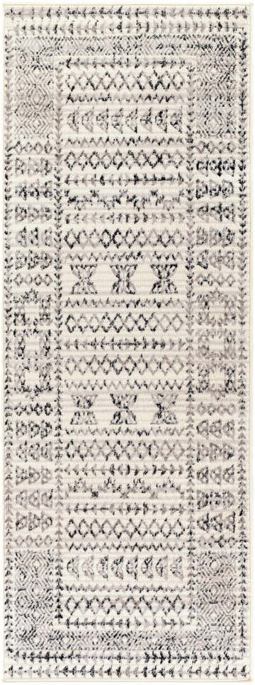 Close-up of the Greig Area Rug. Bohemian style with black, charcoal, and gray geometric patterns on an off-white background. Design-Runner-2773