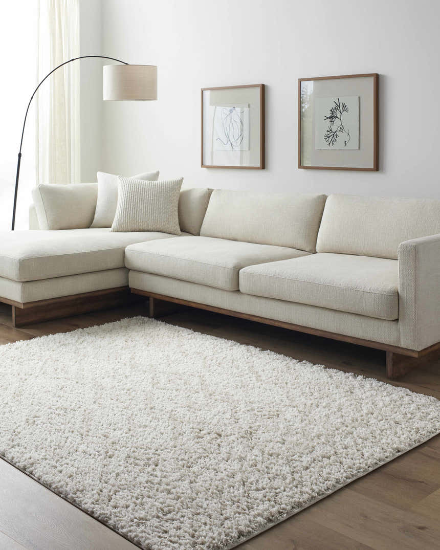 Living room with a white sectional sofa and a plush off-white Grina Area Rug. Roomscene-Rectangle