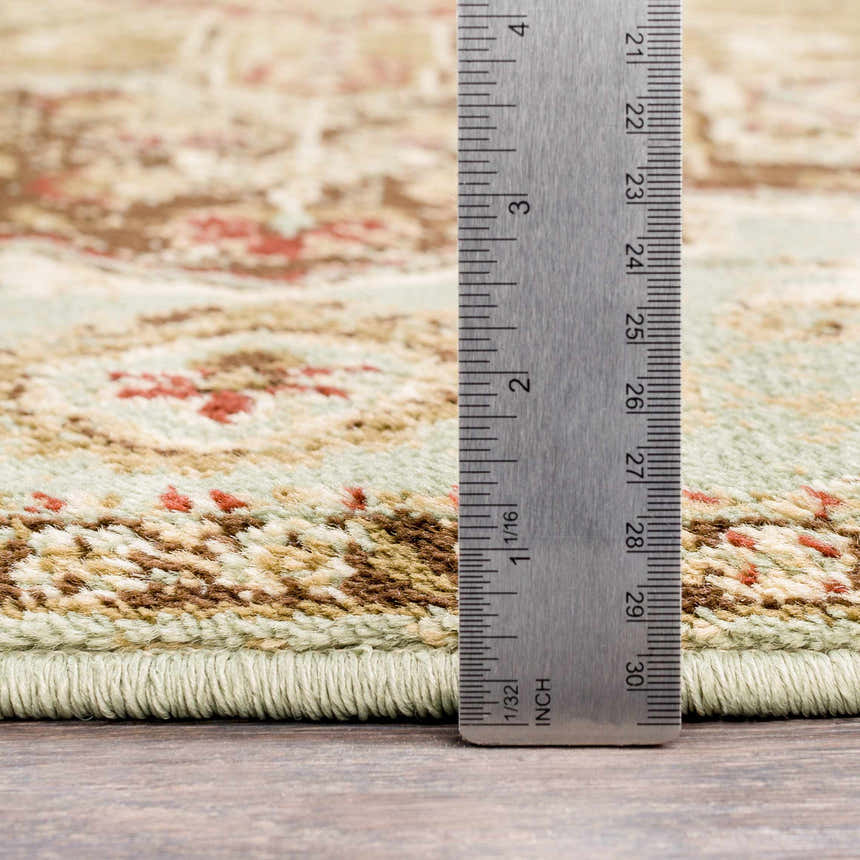 Close up of the Granger Area Rug showing pile height and traditional burgundy, beige, and sage pattern. Pile
