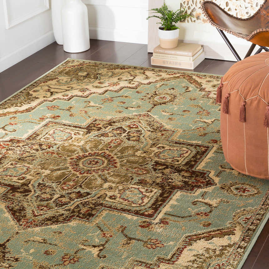 Bohemian style room with a tan pouf and the Granger Area Rug in light beige, sage, and brown. Roomscene-Rectangle