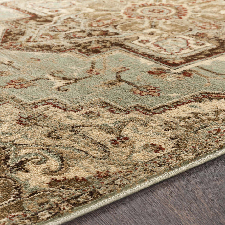 Close-up of the Granger Area Rug. Traditional rug design with burgundy, beige, sage, and brown tones. Texture