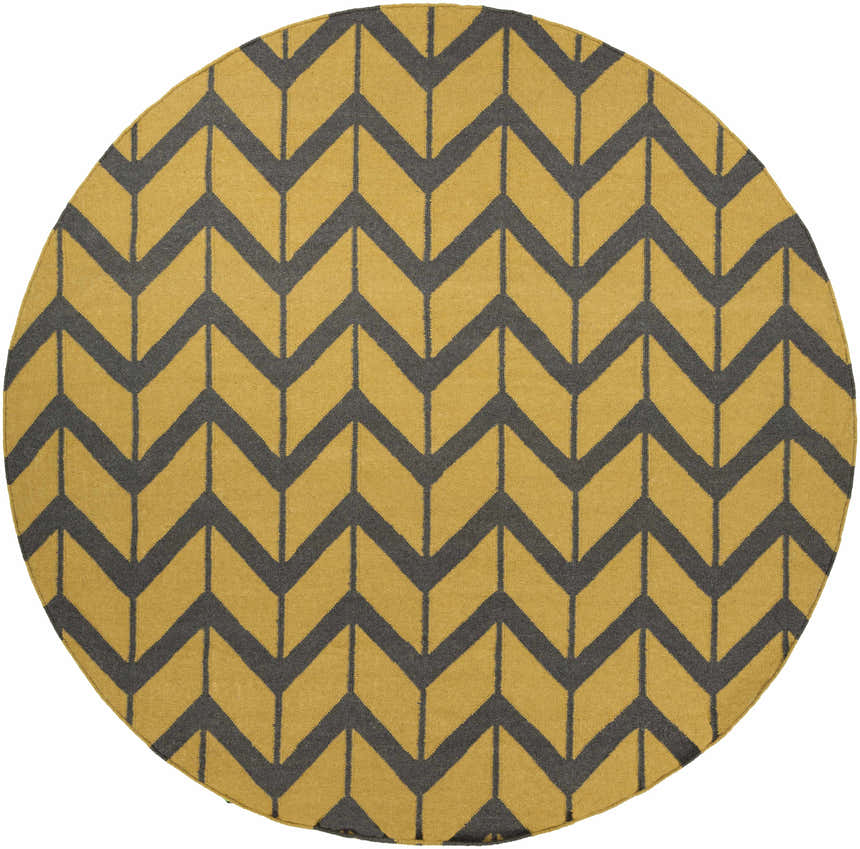 Close-up of a round Groves Area Rug with a charcoal chevron pattern on a mustard yellow wool background. Design-Round-8