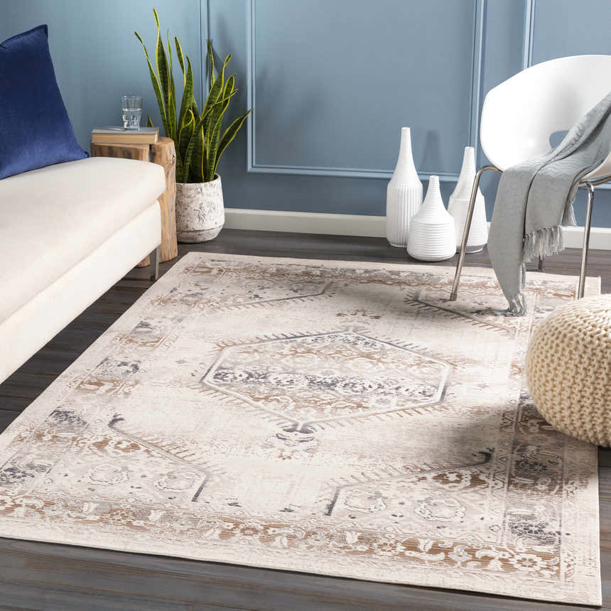 Living room scene with a Hainesville White Medallion rug, cream sofa, white chair, and blue accent wall. Roomscene-Rectangle