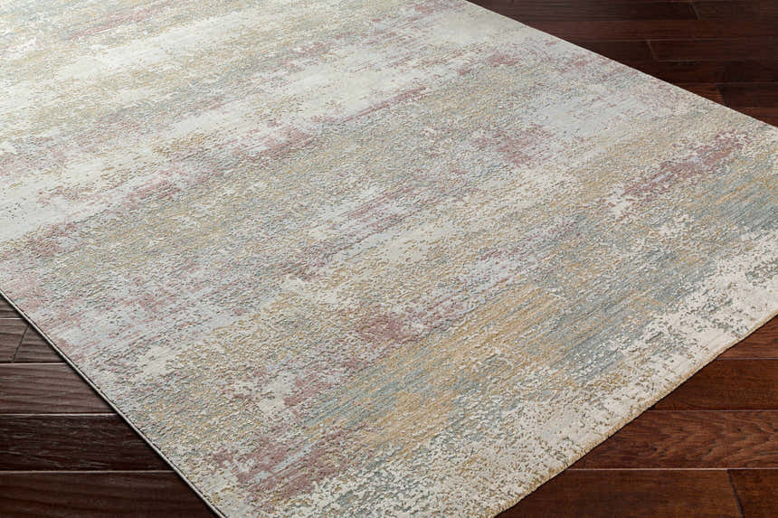 Close up of Hanne Thick Luxe Rug showing its multi brown, gray, and pink abstract pattern and texture. Corner
