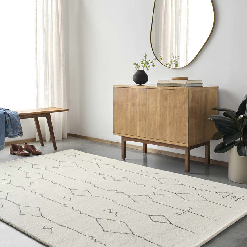 Entryway with beige Hanny Area Rug, wood cabinet, bench, and oval mirror creating a modern farmhouse look. Roomscene-Rectangle