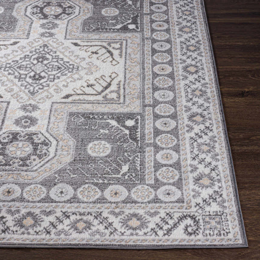 Close-up of the Harrah Gray Cross Rug, showcasing its charcoal, cream, and gray traditional pattern and soft texture. Front