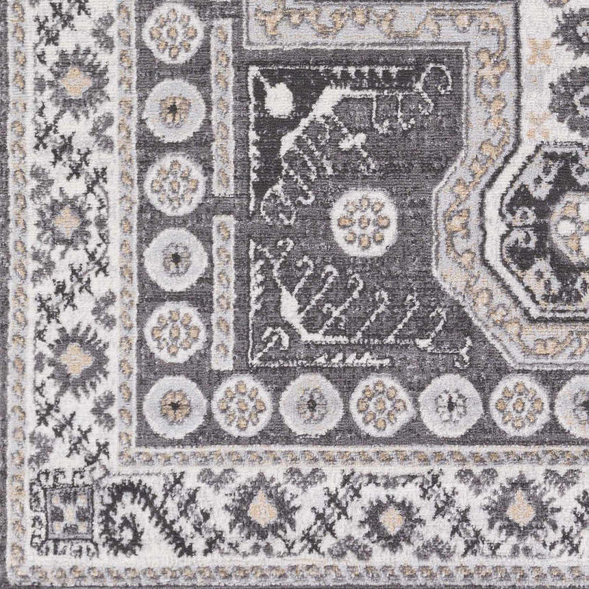 Close-up of the Harrah Gray Cross Rug showing its charcoal, cream, and tan traditional pattern and machine-woven texture. Swatch