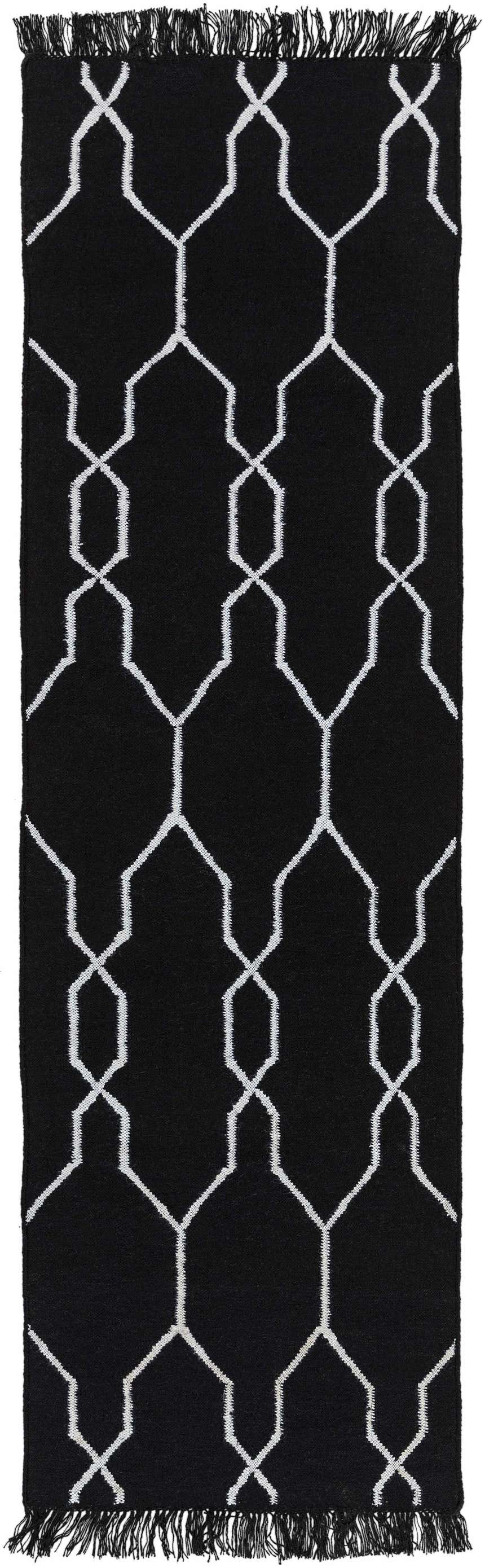 Close-up of the black Hawthorne Indoor Outdoor Rug with a white geometric trellis pattern and fringe. Design-Runner-268
