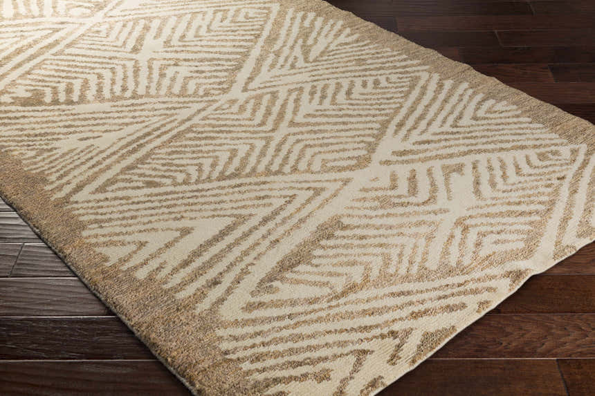Close-up of the Hendon Jute Clearance Rug. Tan geometric pattern on ivory jute rug. Farmhouse style. Corner