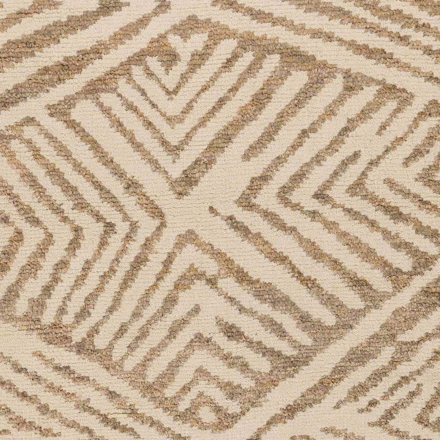 Close-up of the Hendon Jute Clearance Rug. Ivory rug with a tan geometric diamond pattern and hand woven texture. Swatch