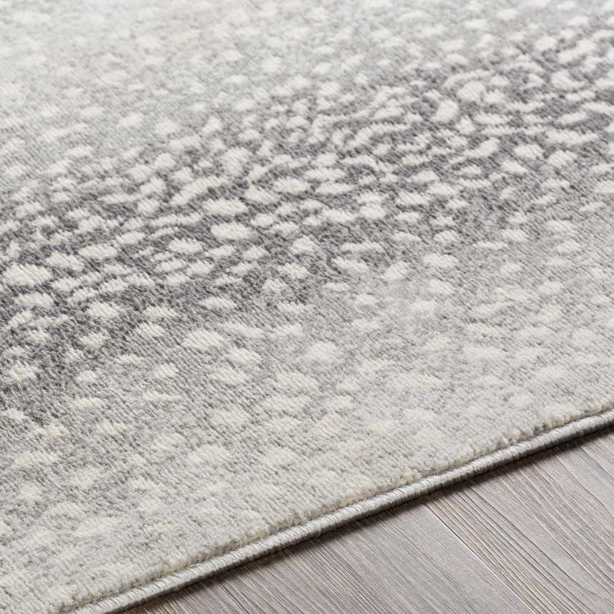 Close up of Pointblank Black&Gray Antelope Print Rug showing charcoal, ivory and gray tones. Machine woven texture. Texture
