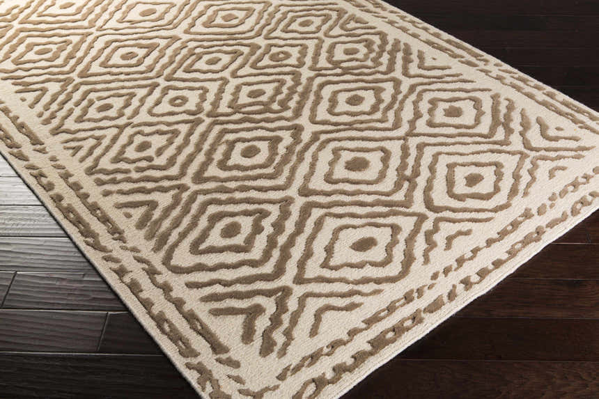 Close-up of Halesworth Premium Area Carpet, a hand-knotted wool rug with a brown geometric diamond pattern on light beige. Corner
