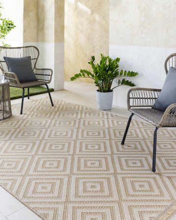 Patio scene with beige Uaine Washable Jute Rug, woven diamond pattern, and two wicker chairs with gray cushions. Roomscene-Rectangle