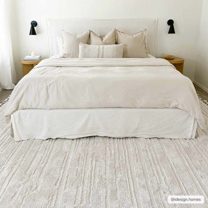 Bedroom scene with textured ivory Ibarra rug under bed. Neutral color palette, modern farmhouse style. Roomscene-Rectangle