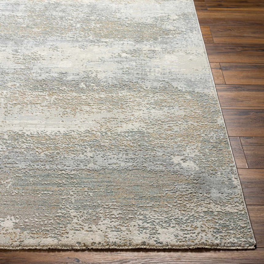 Close-up of the Ikram Thick Luxe Boutique Rug. Abstract design in cloud gray, dark gray, and light gray on dark wood floors. Front