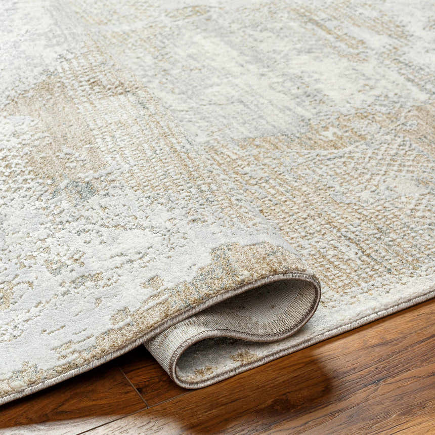 Close-up of the Indah Thick Luxe Area Rug showing its cloud gray, brown, and light gray contemporary design and plush texture. Fold