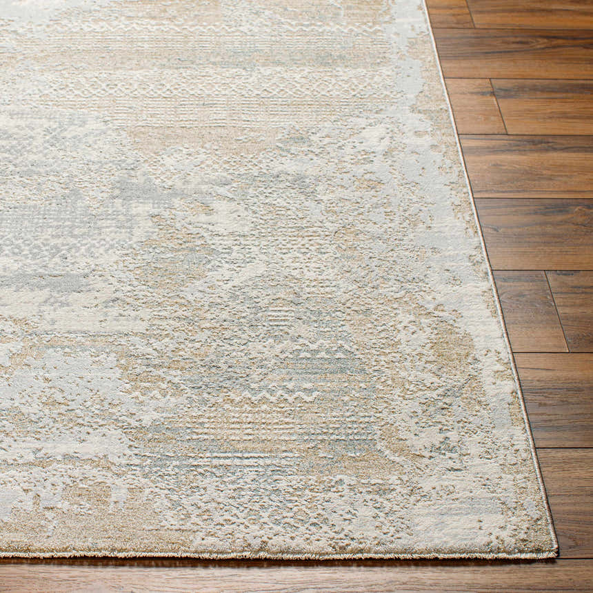 Close-up of Indah Thick Luxe Area Rug showing cloud gray, beige, and subtle pattern on dark wood floor. Front
