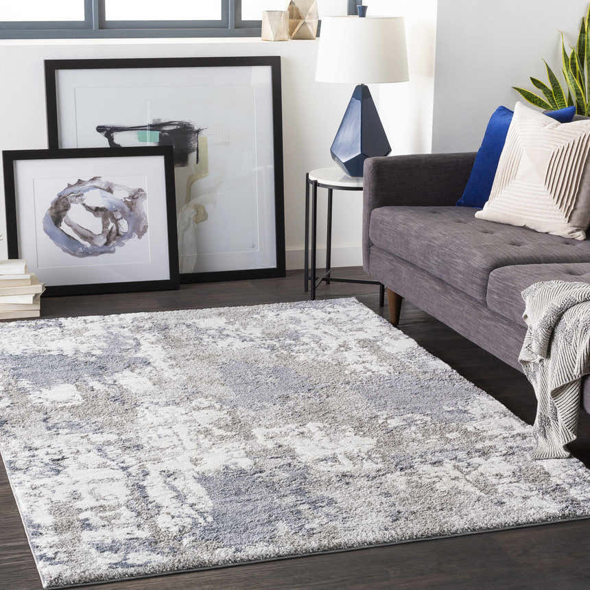 Living room scene with gray sofa and the denim, ivory Iroquois Area Rug. Roomscene-Rectangle