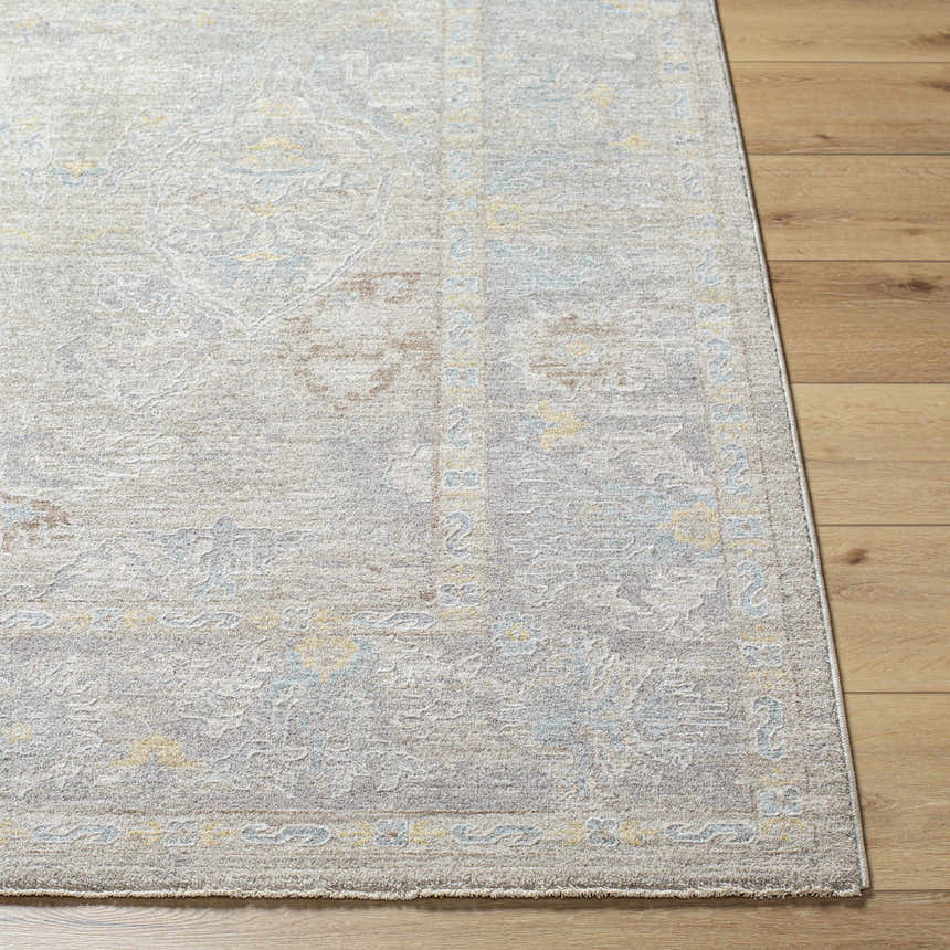 Close-up of the Istas Thick Luxe Area Rug in cloud gray, showing the traditional pattern and soft texture on wood floors. Front