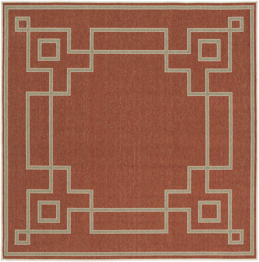 Close-up of the Jarrell Area Rug. Brick red olefin rug with a light beige geometric border pattern. Machine woven. Design-Square-73