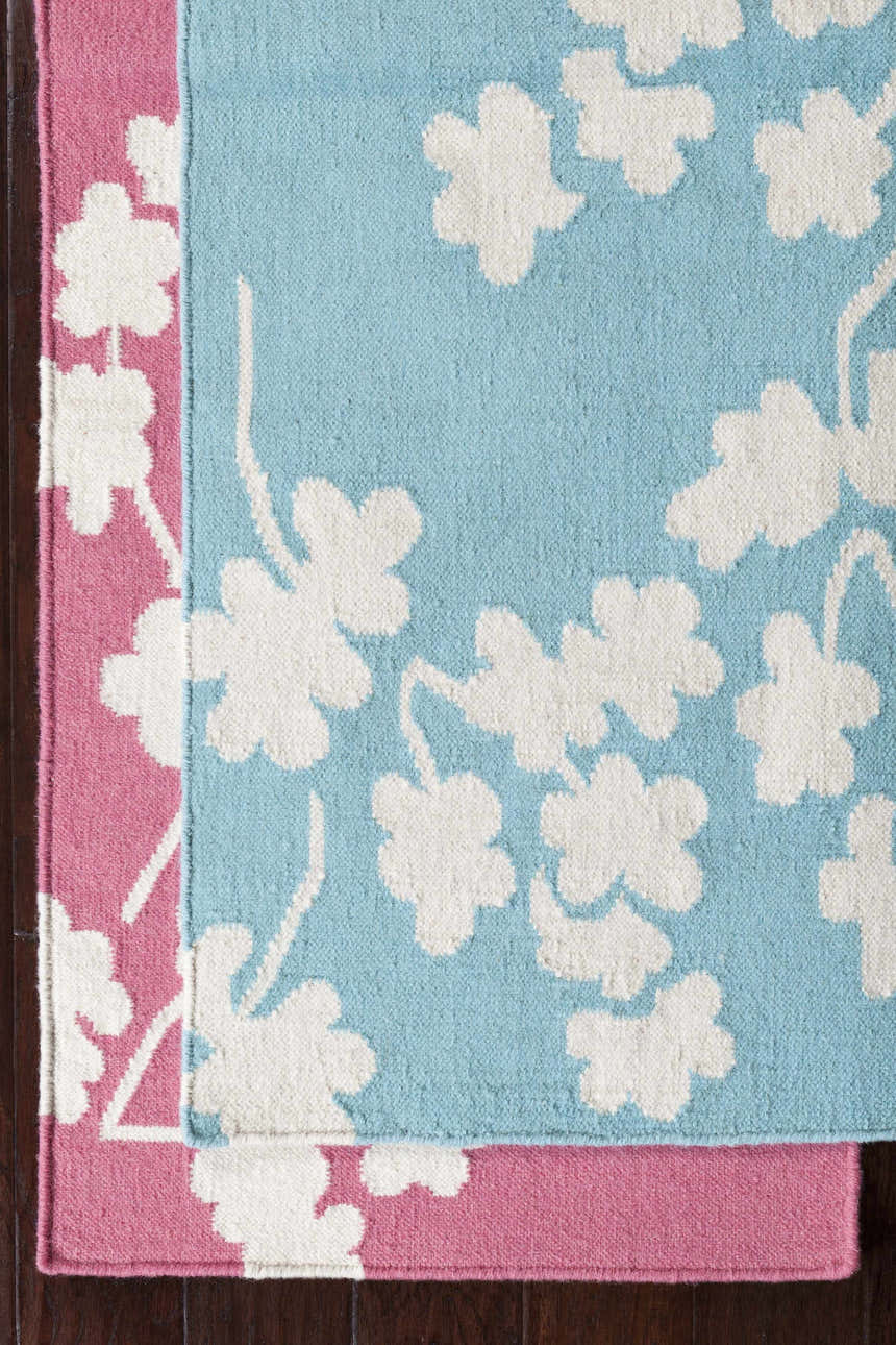 Close up of the hand woven Johnstown Area Carpet in light beige, rose, and white floral pattern. Styleshot