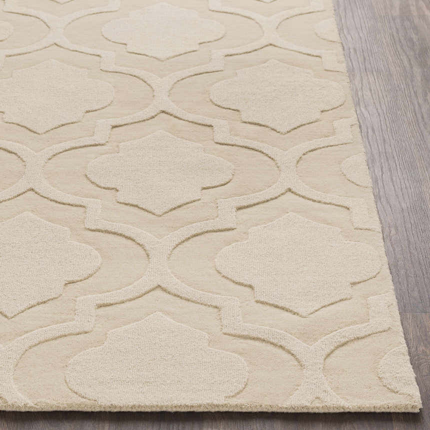 Close-up of the Kake Carpet in tan. Hand-loomed wool rug features a contemporary geometric trellis pattern. Front