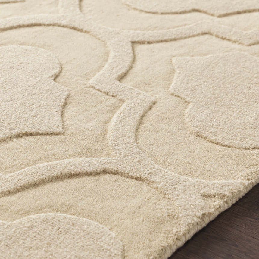 Close up of the tan, hand-loomed Kake Carpet showing its geometric pattern and wool texture. Texture
