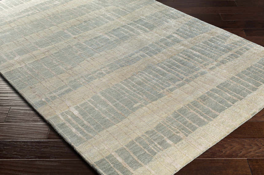 Close-up of Kalaheo Premium Rug, a sage and cream hand-knotted wool rug with a contemporary plaid design. Corner