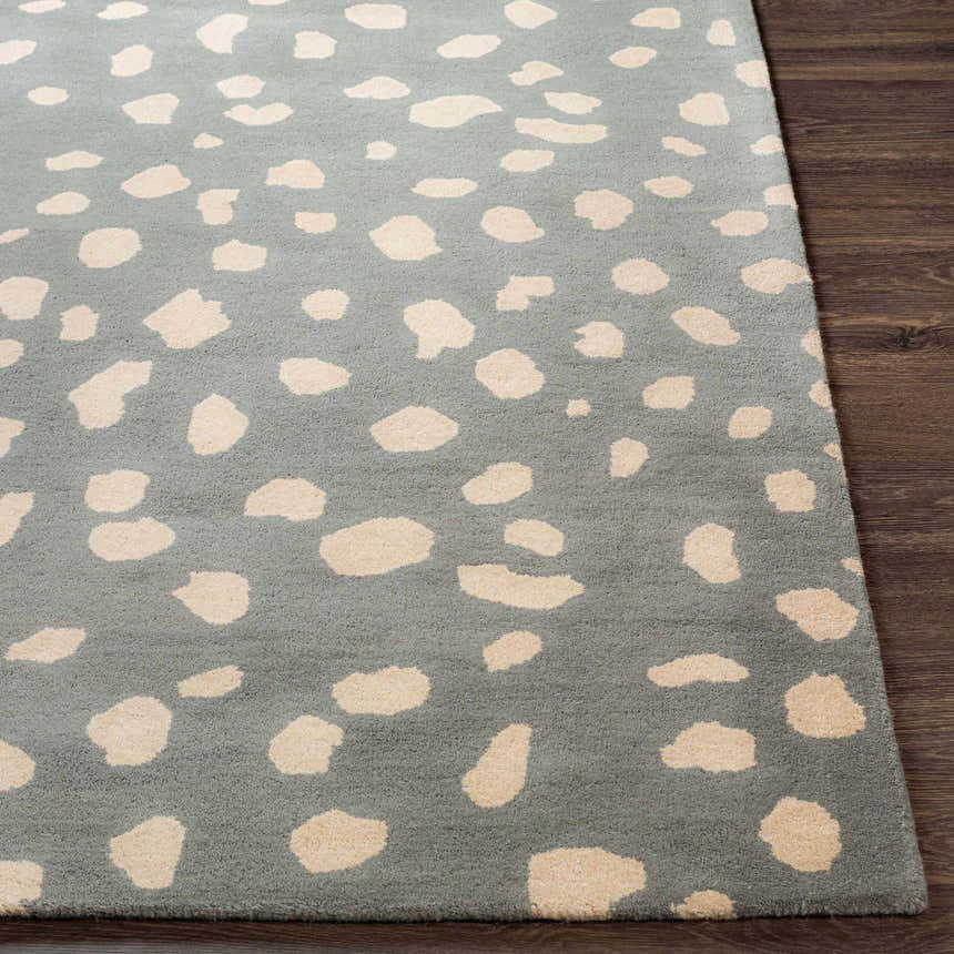 Close-up of the Kaweah Dalmatian Print Carpet. Features a gray background with tan animal spots and hand-tufted texture. Front